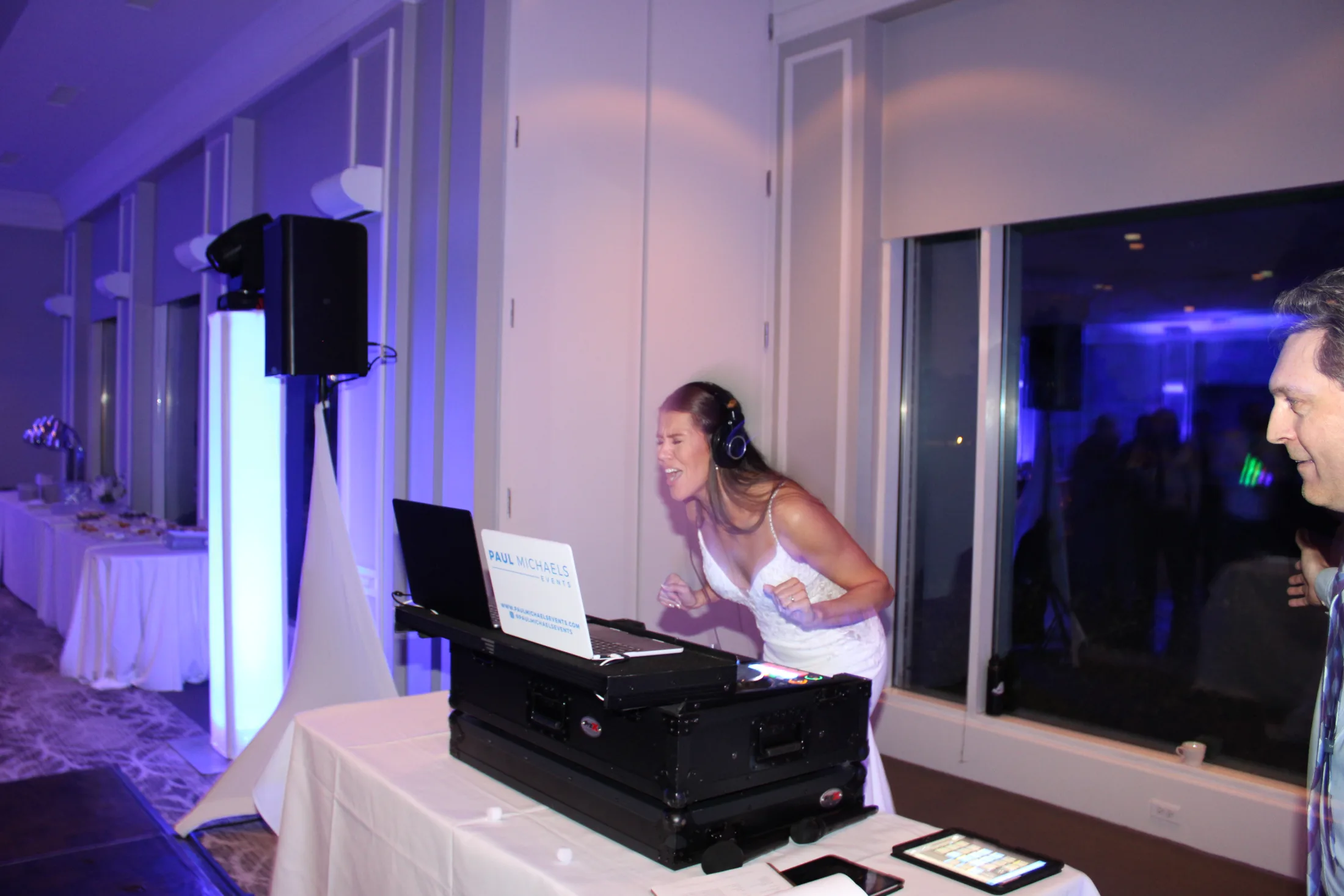 A wedding DJ setup with a DJ booth and speakers at The Grove Country Club in Long Grove.