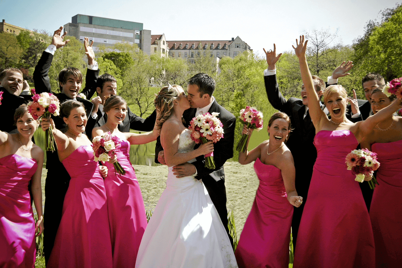 Bride and Groom Kissing Surrounded by Bridal Party