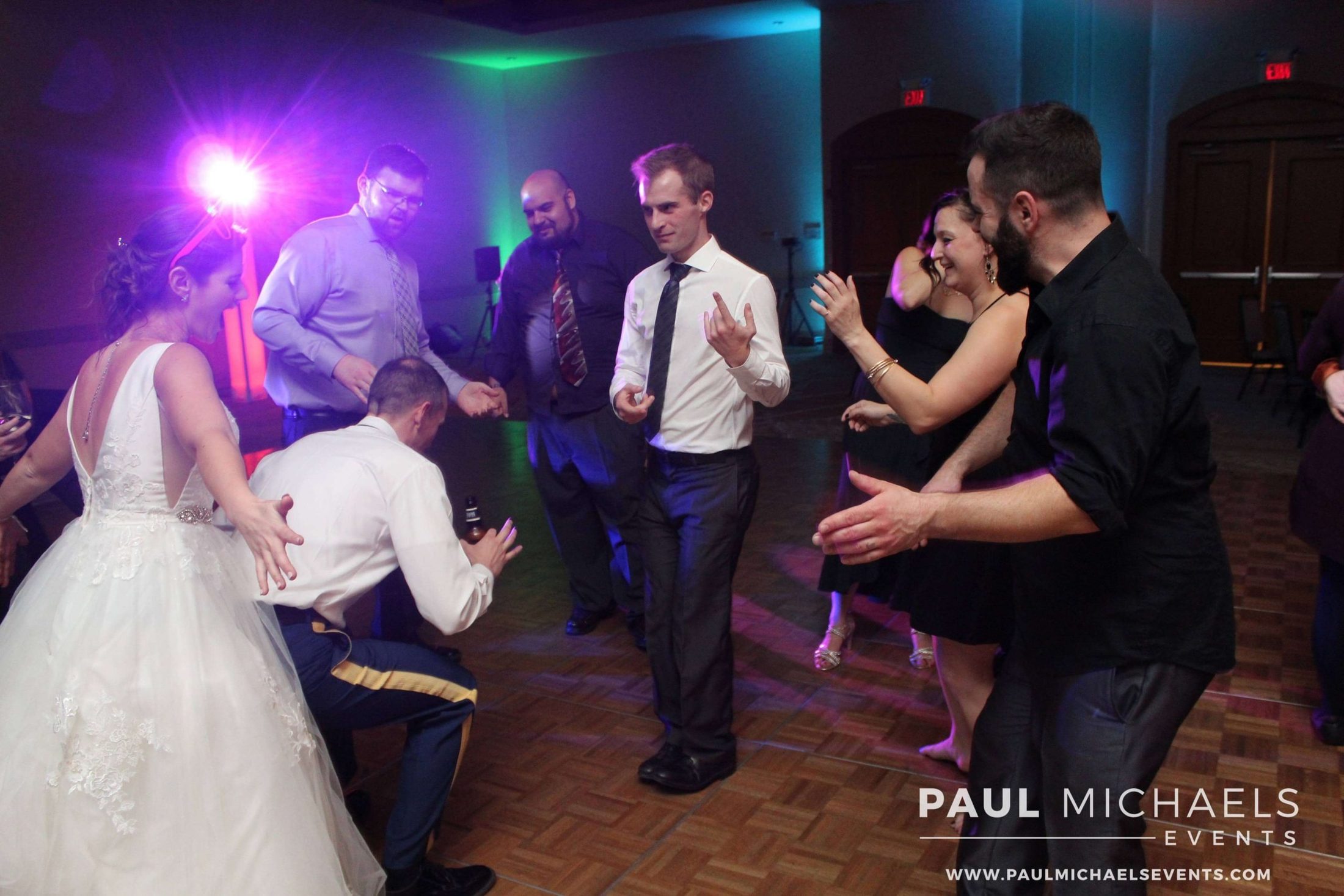bride, groom, and guests dancing at a wedding