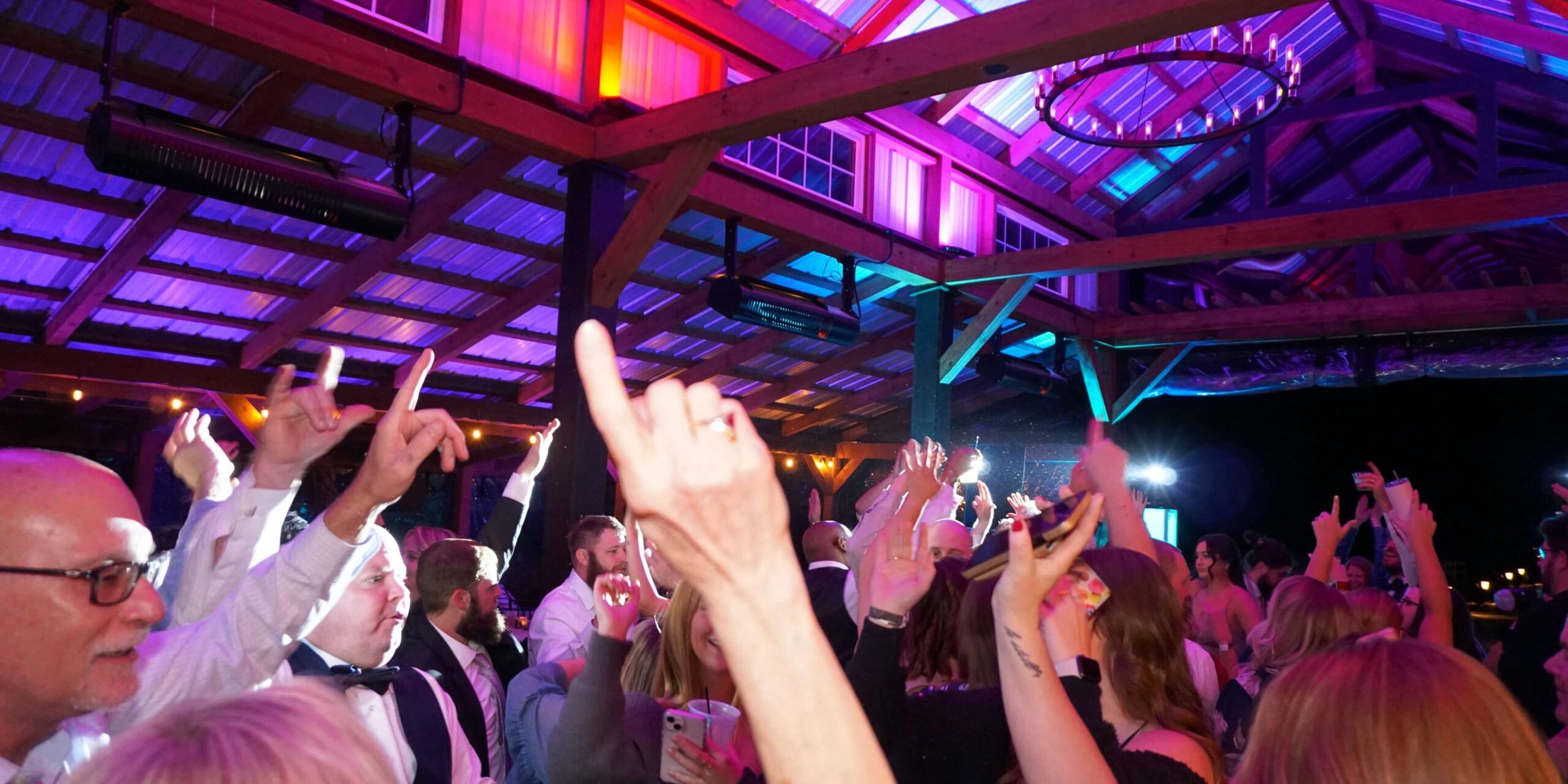 Hands up in the air as guests dance the night away on thedance floor at Harpor's Vineyard in New Virgina, Iowa, with music provided by DJ Paul Michaels from Paul Michaels Events