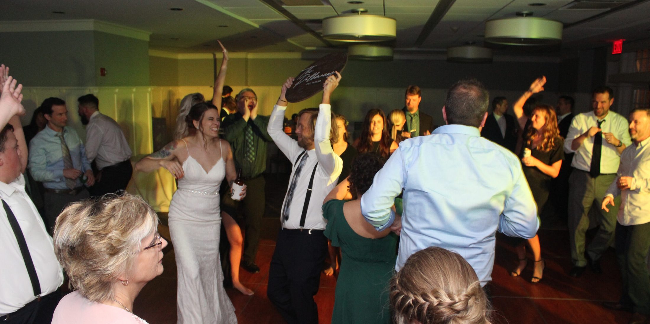 Bride and groom surrounded by loved ones, dancing the night away on the dance floor, with music provided by DJ Paul Michaels from Paul Michaels Events