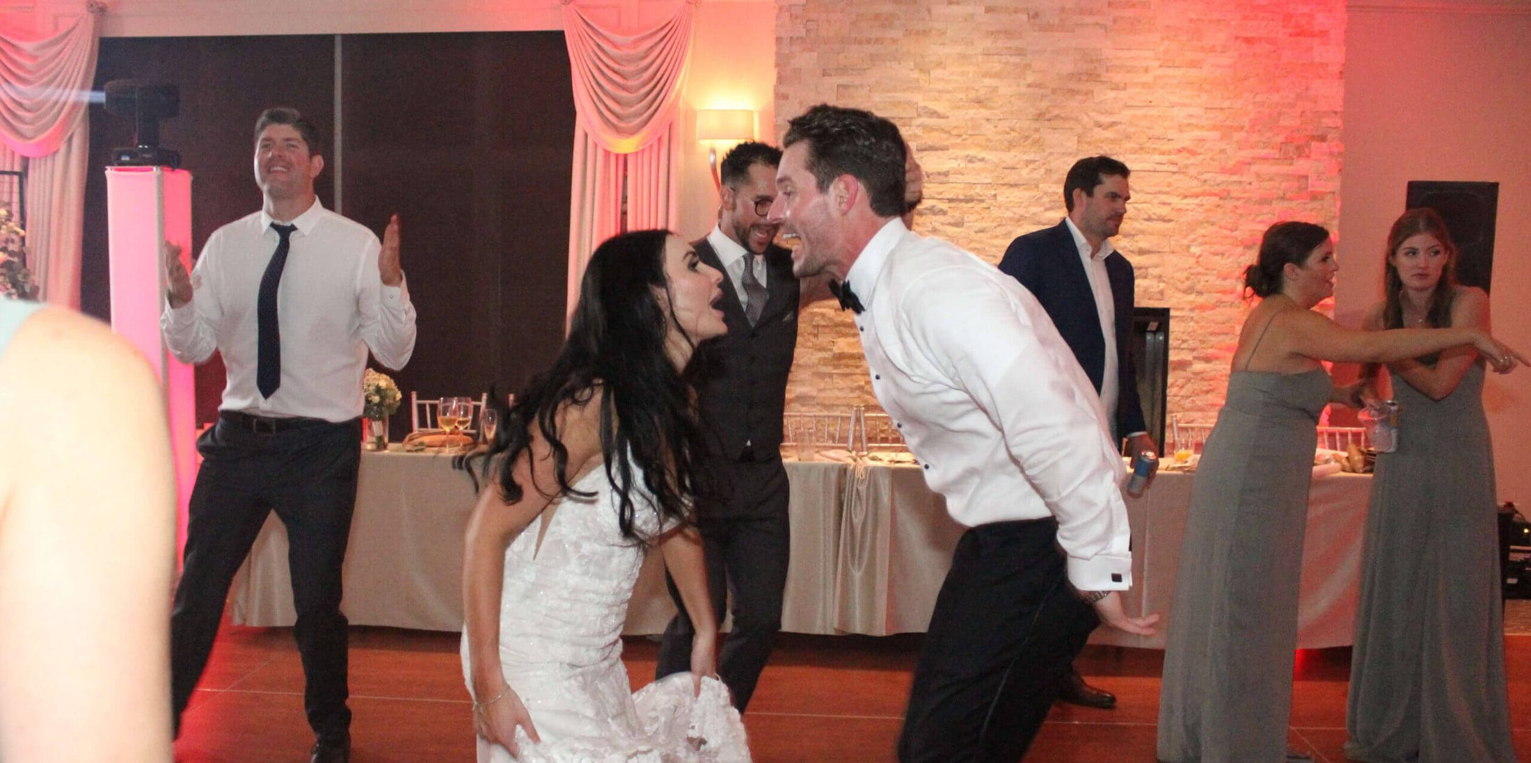 Bride and groom shouting to each other on the dance floor, dancing and singing along to music by Paul Michaels Events DJ Company, the best wedding DJ in Chicagoland