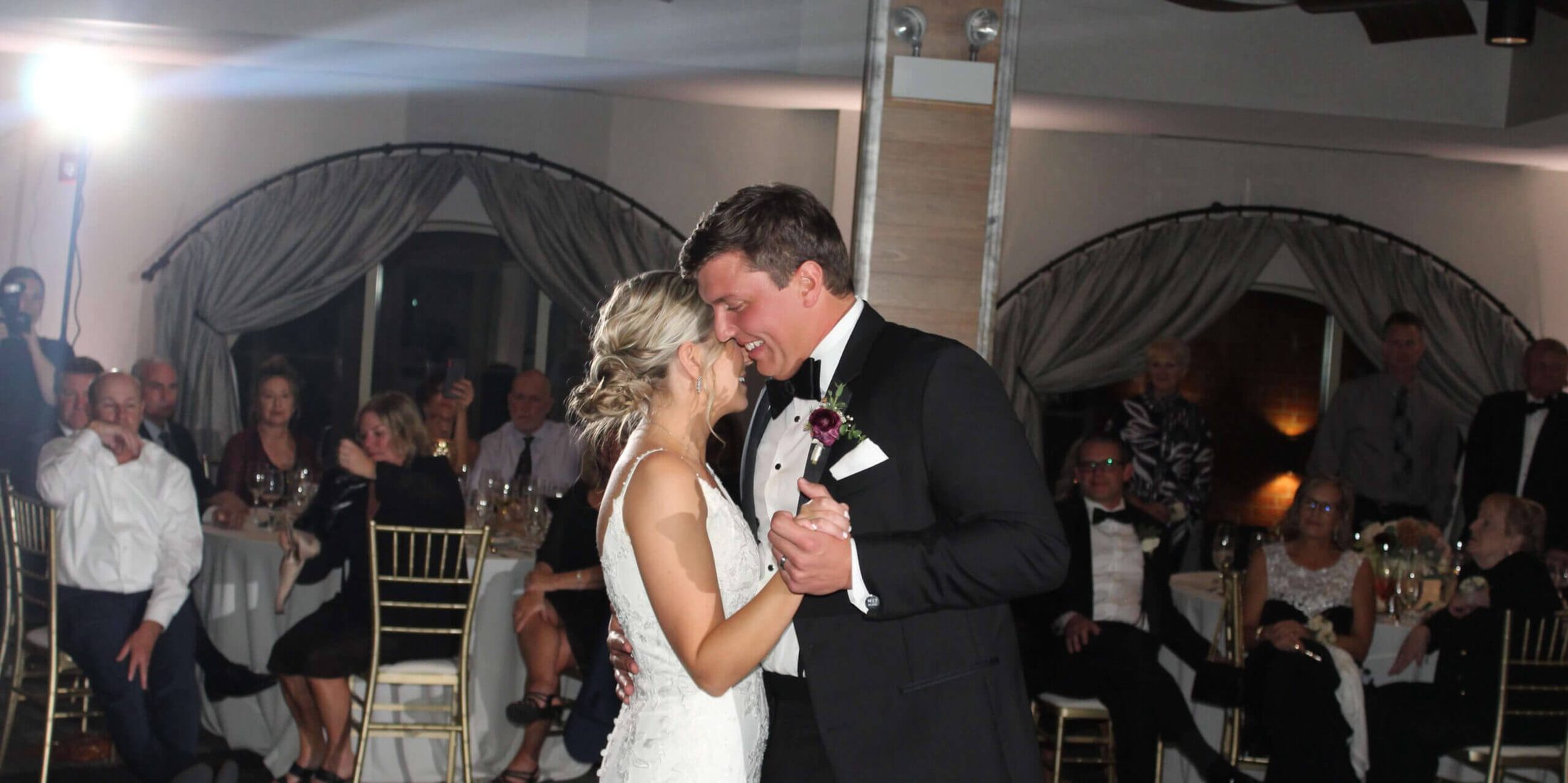 Bride and groom sharing first dance at Elements on Water Street in Naperville, Illinois, with DJ services by Paul Michaels Events, a Chicago suburbs wedding DJ