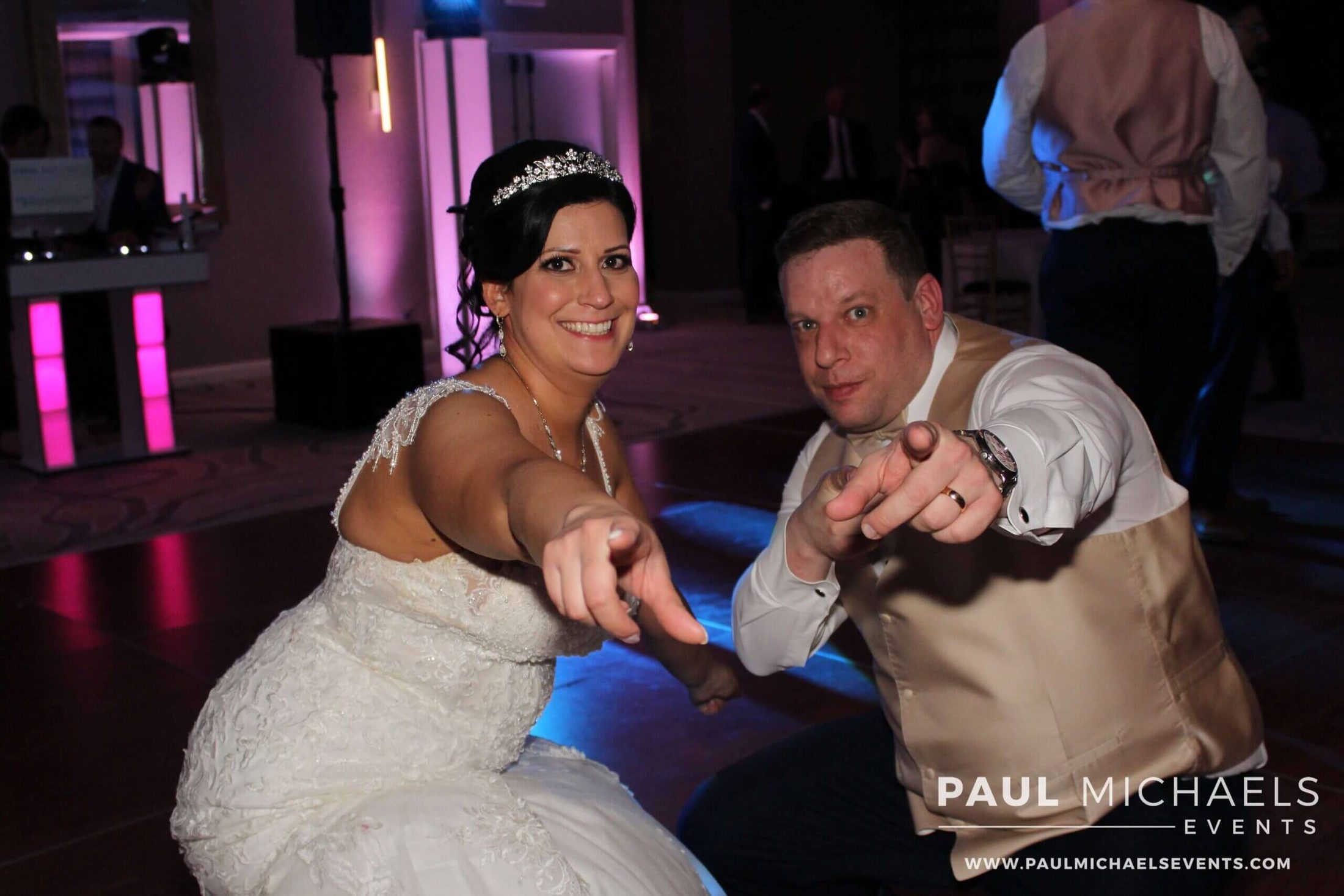 Bride and groom striking a pose to the camera while dancing to the best Chicago suburbs wedding DJ at DoubleTree Hilton Hotel Chicago in Skokie, Illinois