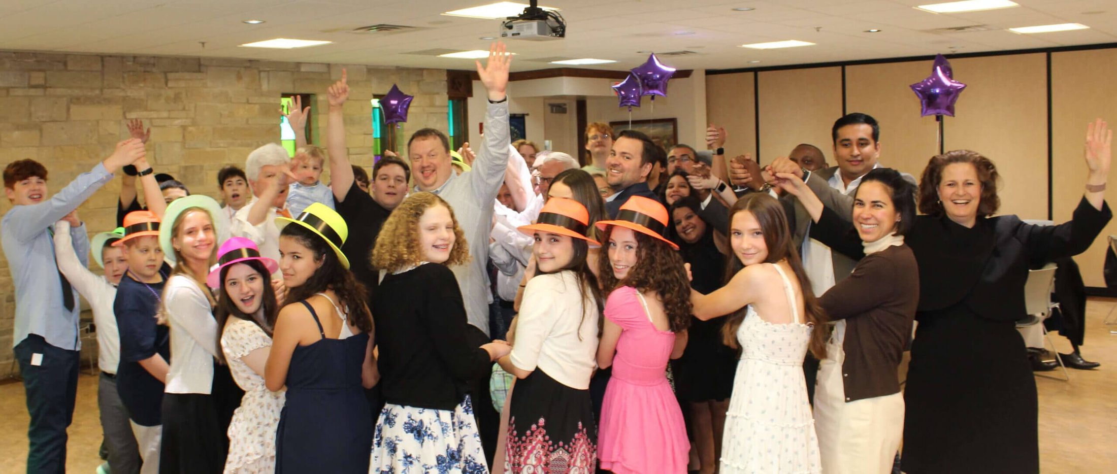 A group of people at a Bar Mitzvah celebration enjoying the best Bar Mitzvah DJ services by Paul Michaels Events