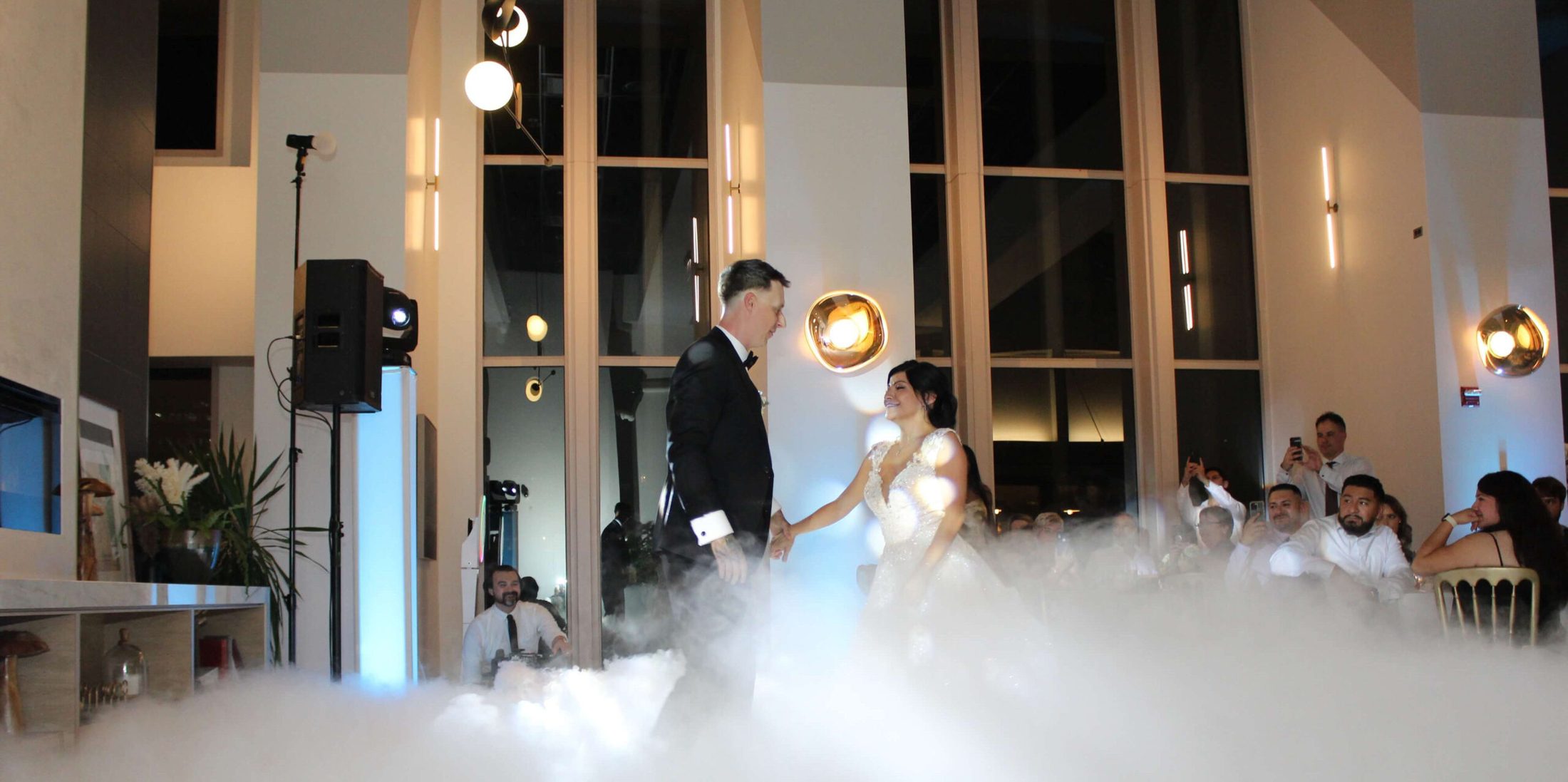 Bride and groom sharing their first dance, with music