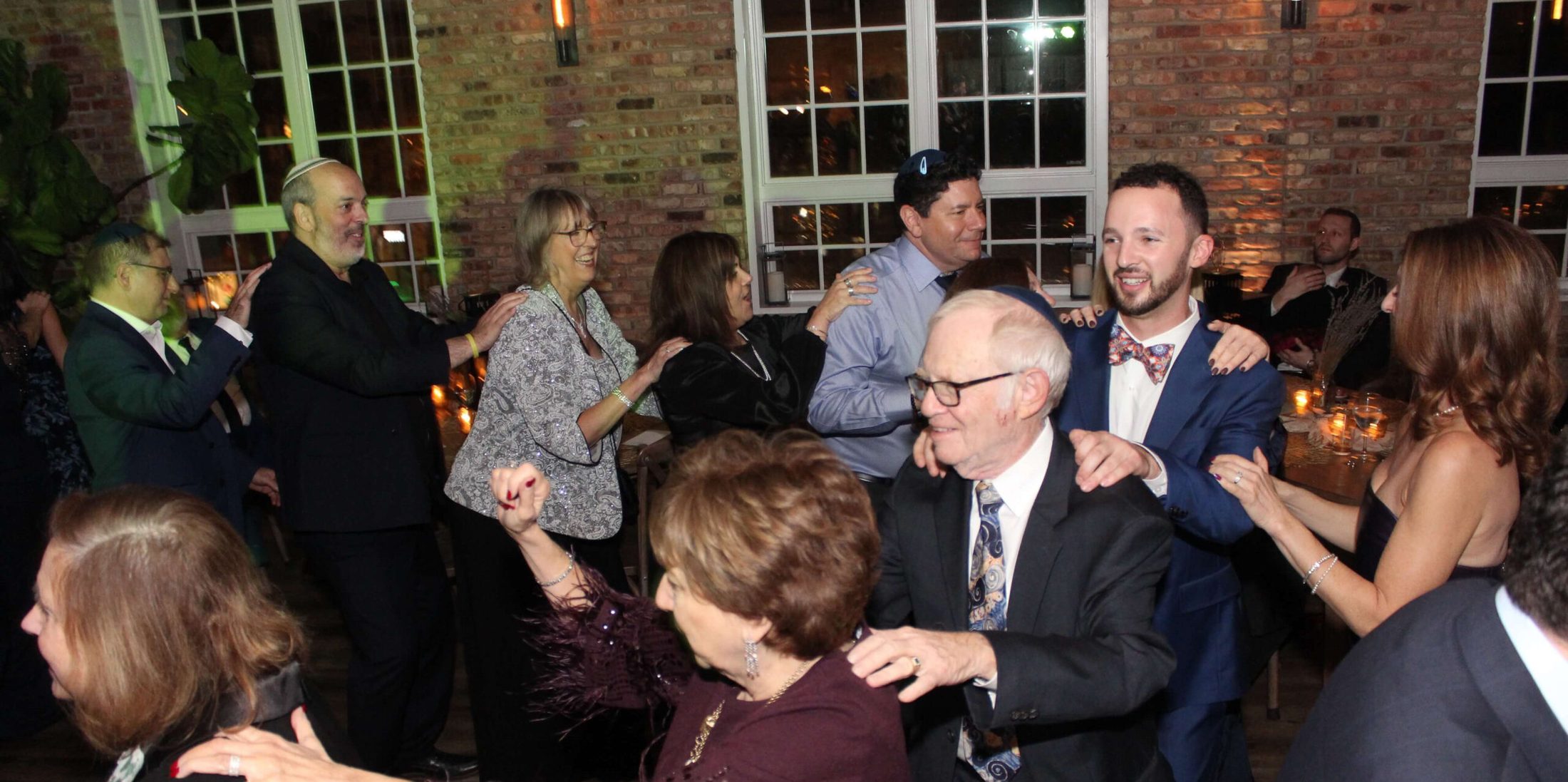 A group of people dancing at a Jewish wedding