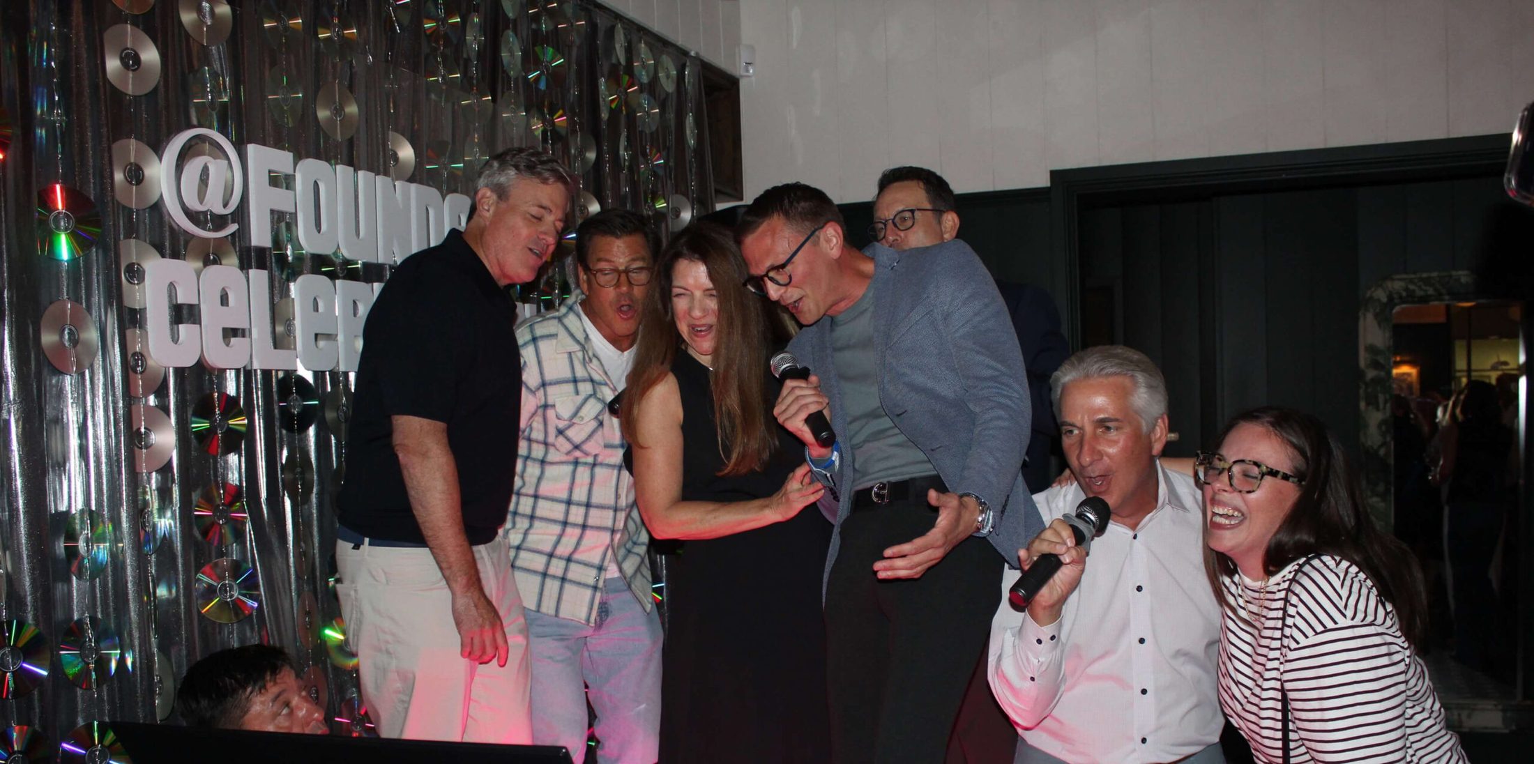 Group of people singing karaoke with music a