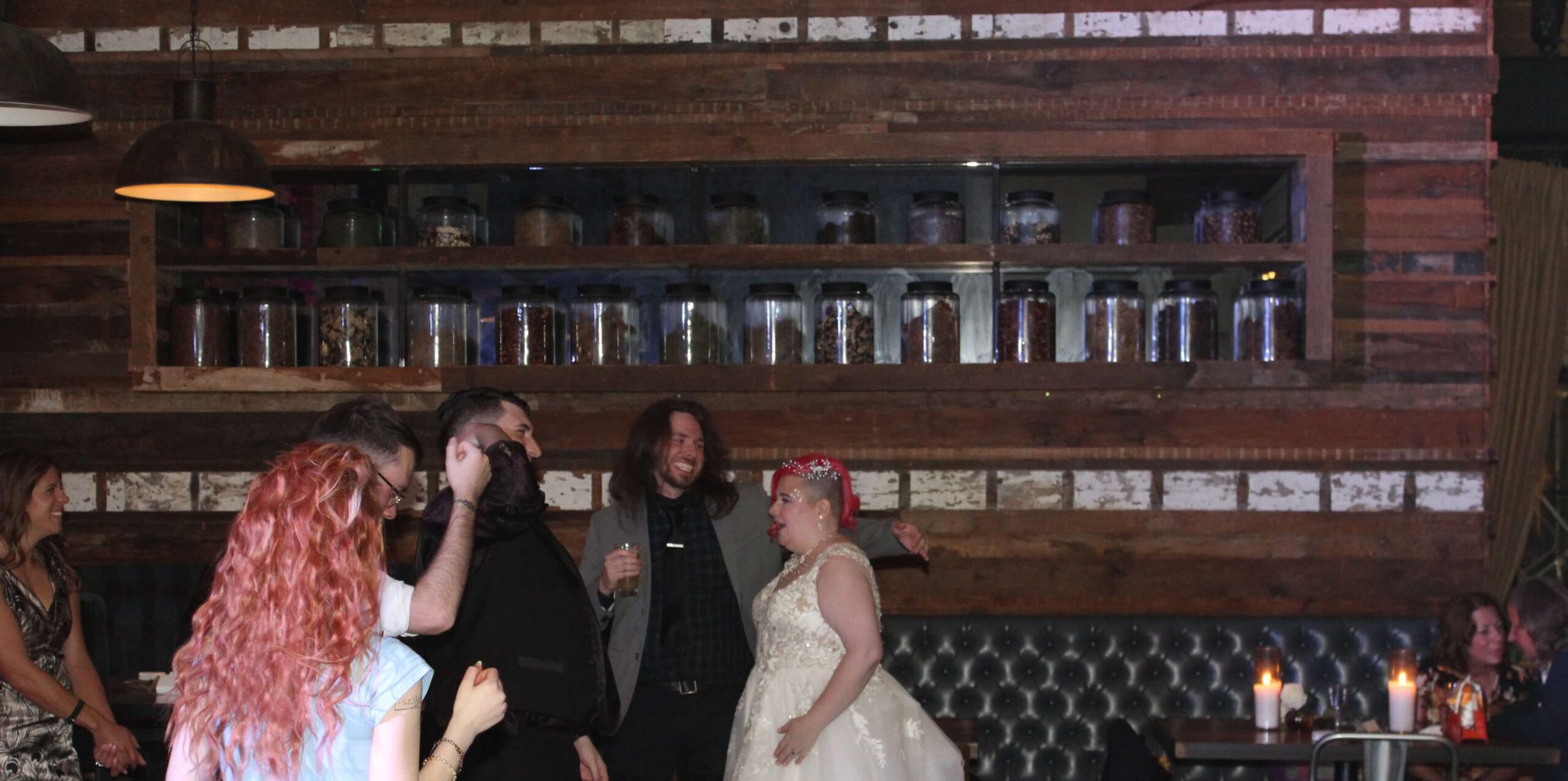 Bride and groom on the dance floor with friends.